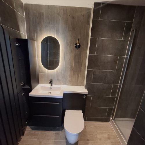 Black tile, wooden floor and accents, bathroom